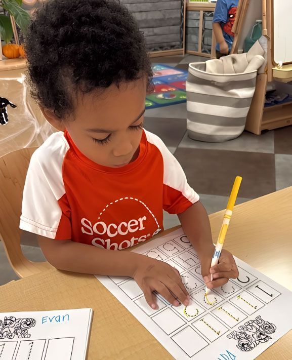 Montessori preschool child tracing numbers for early math practice.