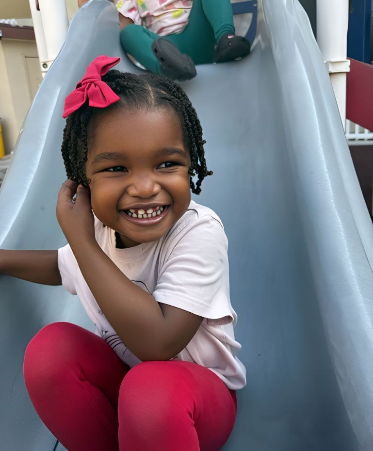 montessori children on playground slide