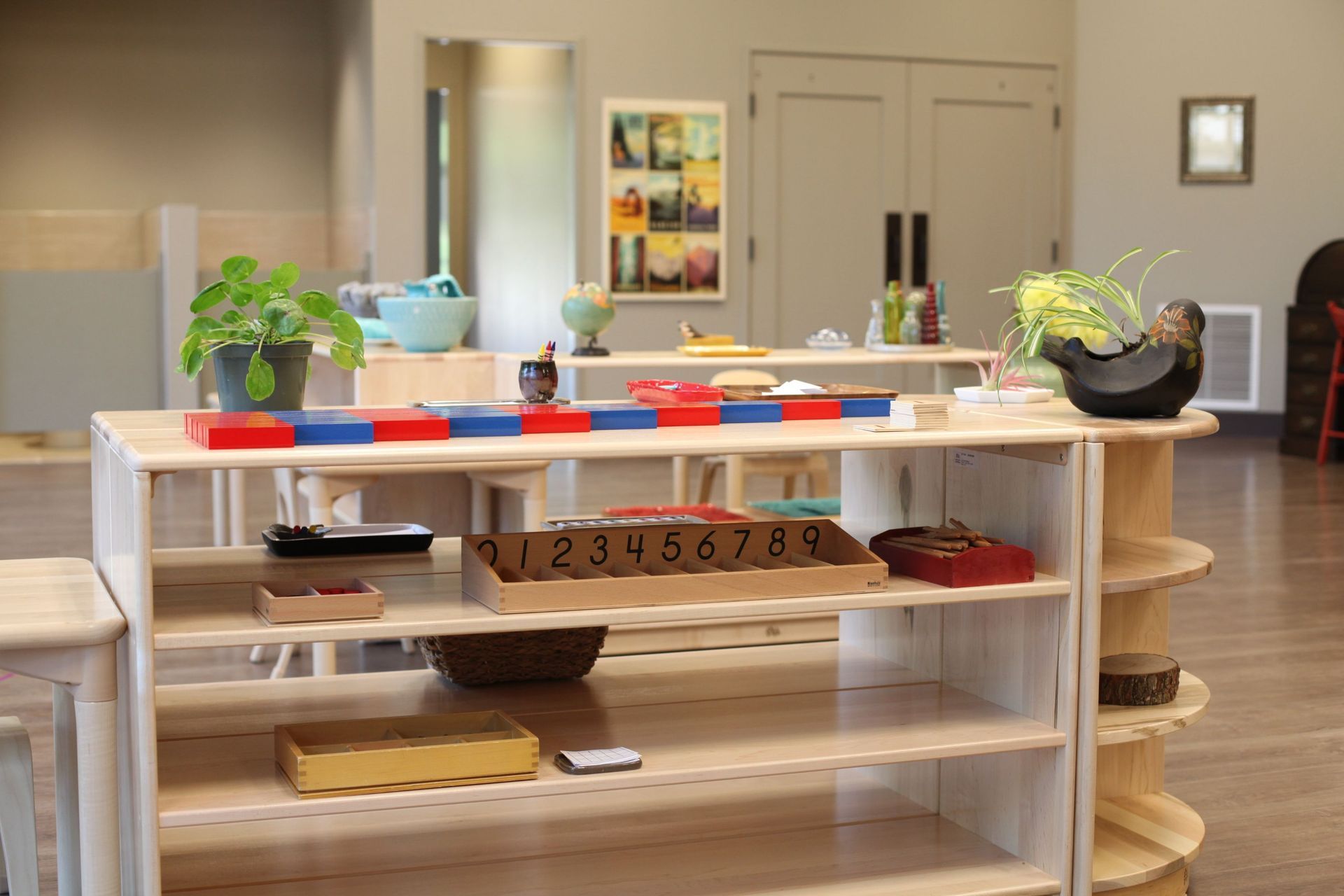 A shelf with materials in a Montessori classroom.
