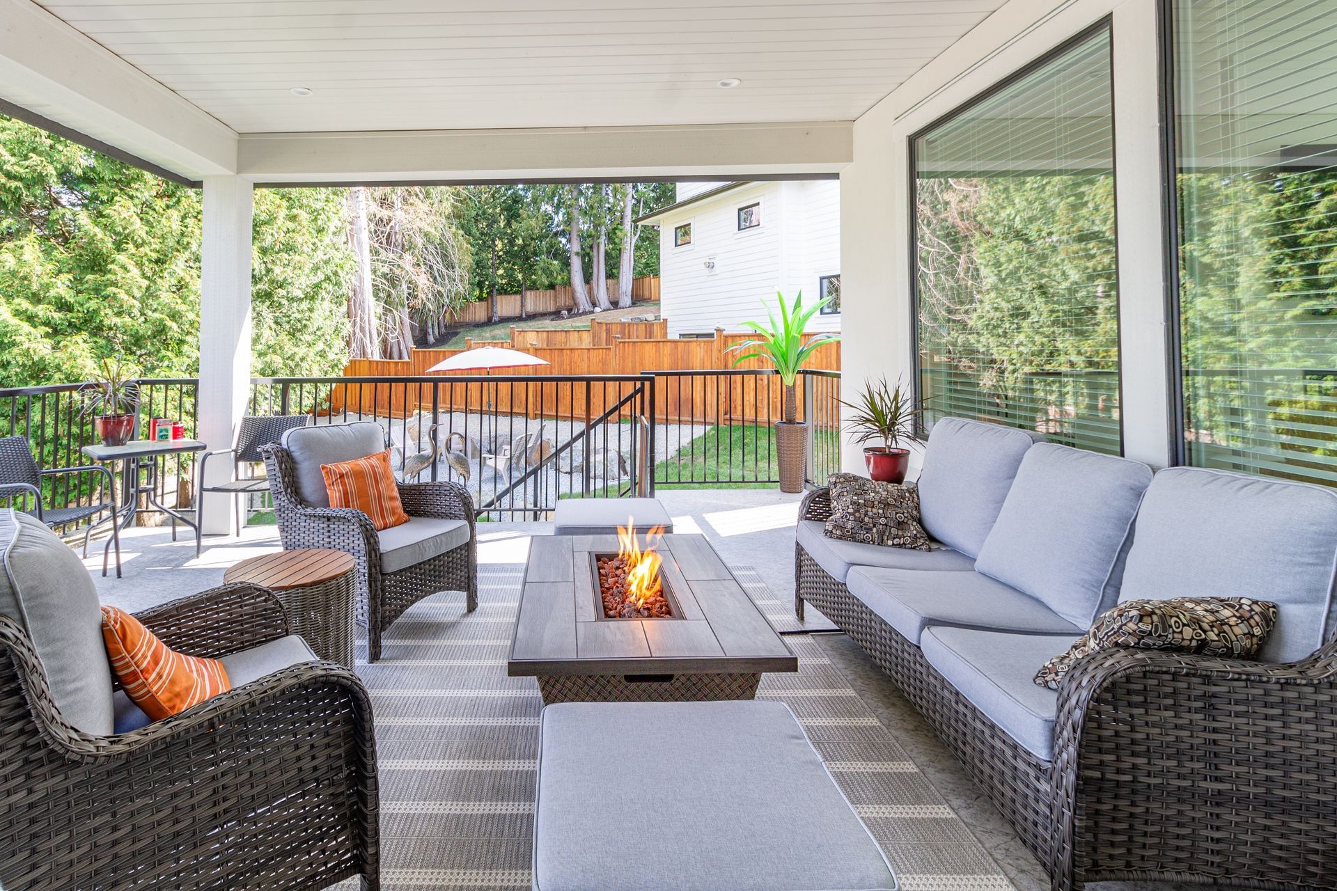 a patio with wicker furniture and a fire pit