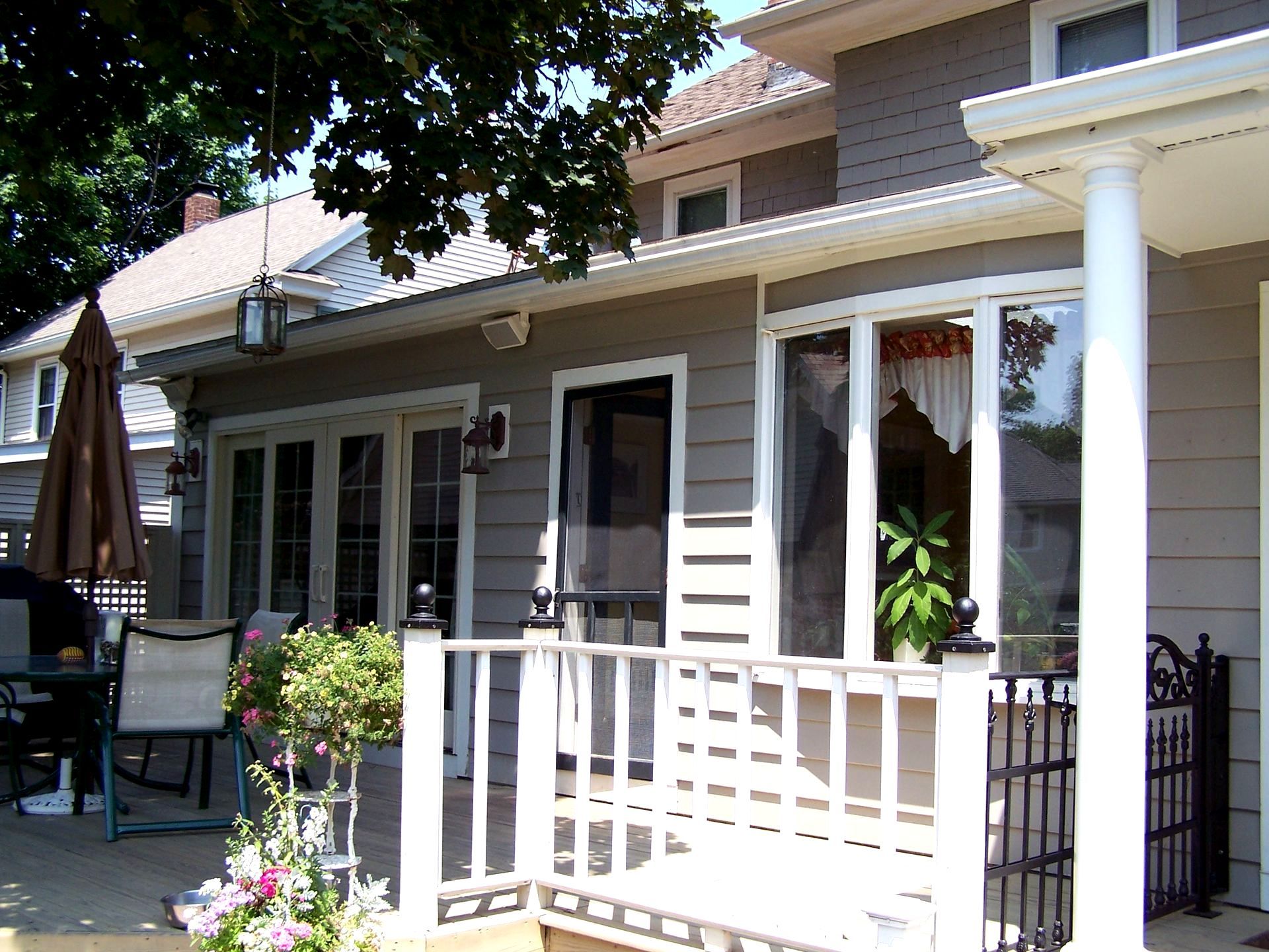 A house with a porch and a sign that says 