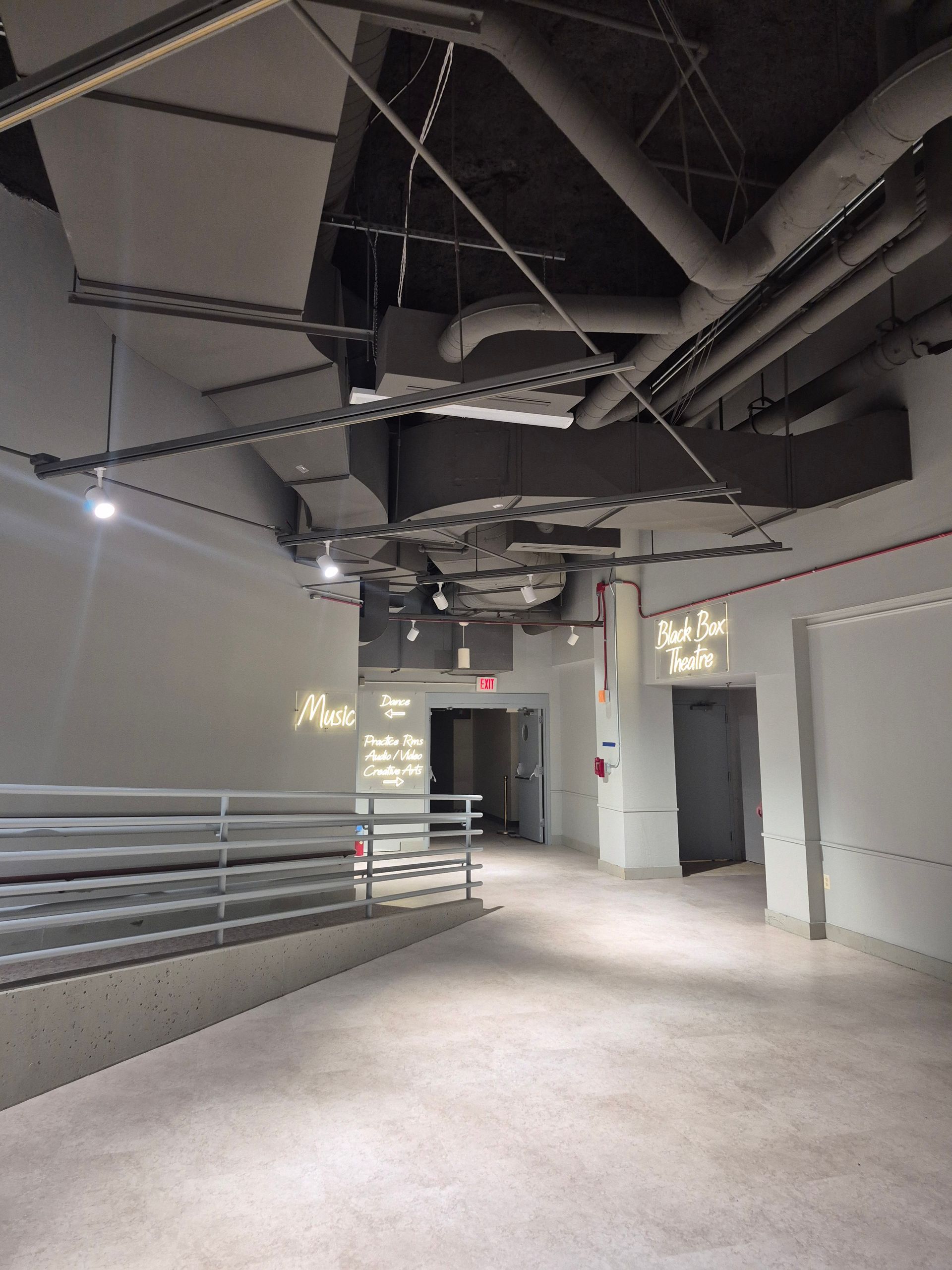 A large empty room with a sign that says exit