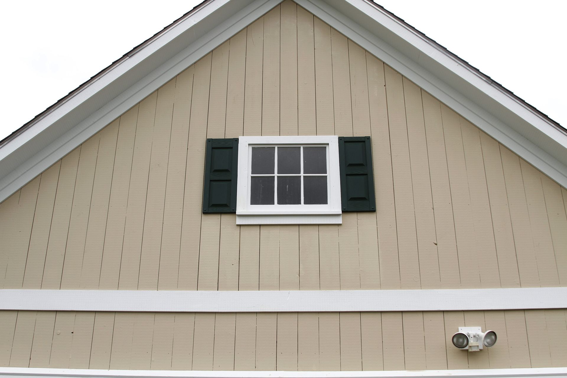 A house with a window and black shutters on it