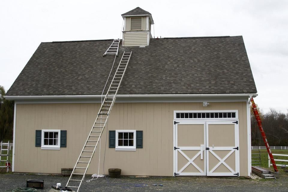 A barn with a ladder on the side of it
