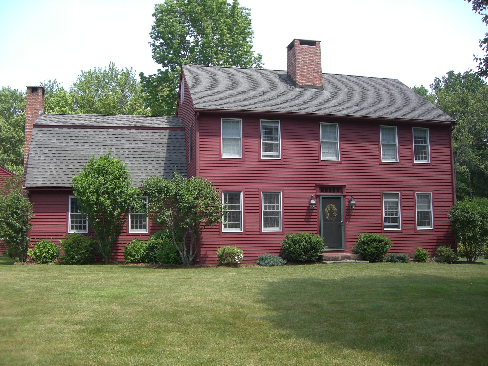 A large red house with a black door