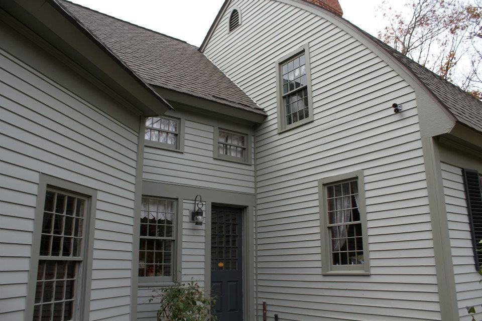 A large white house with many windows and a chimney