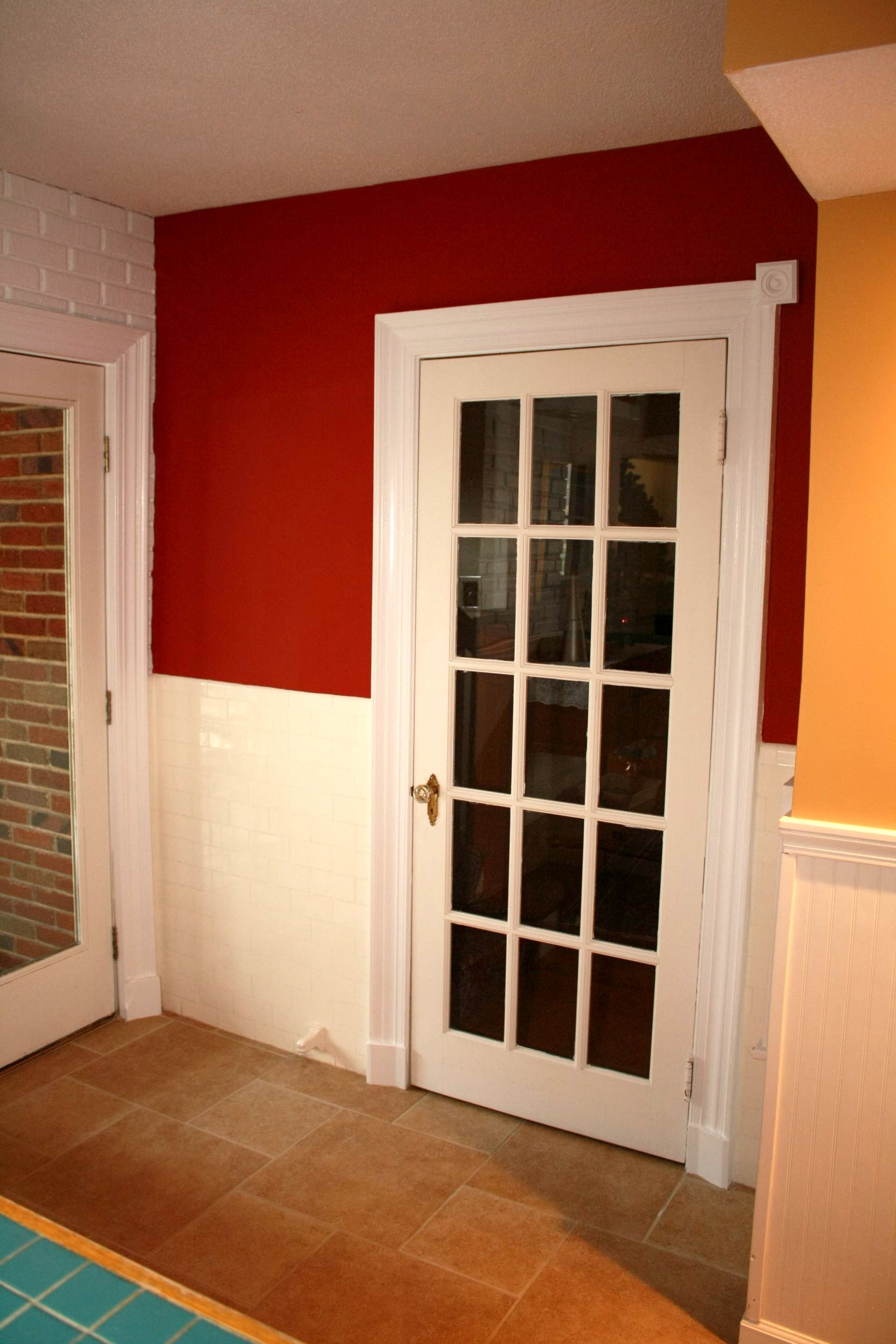 A white door with a red wall behind it