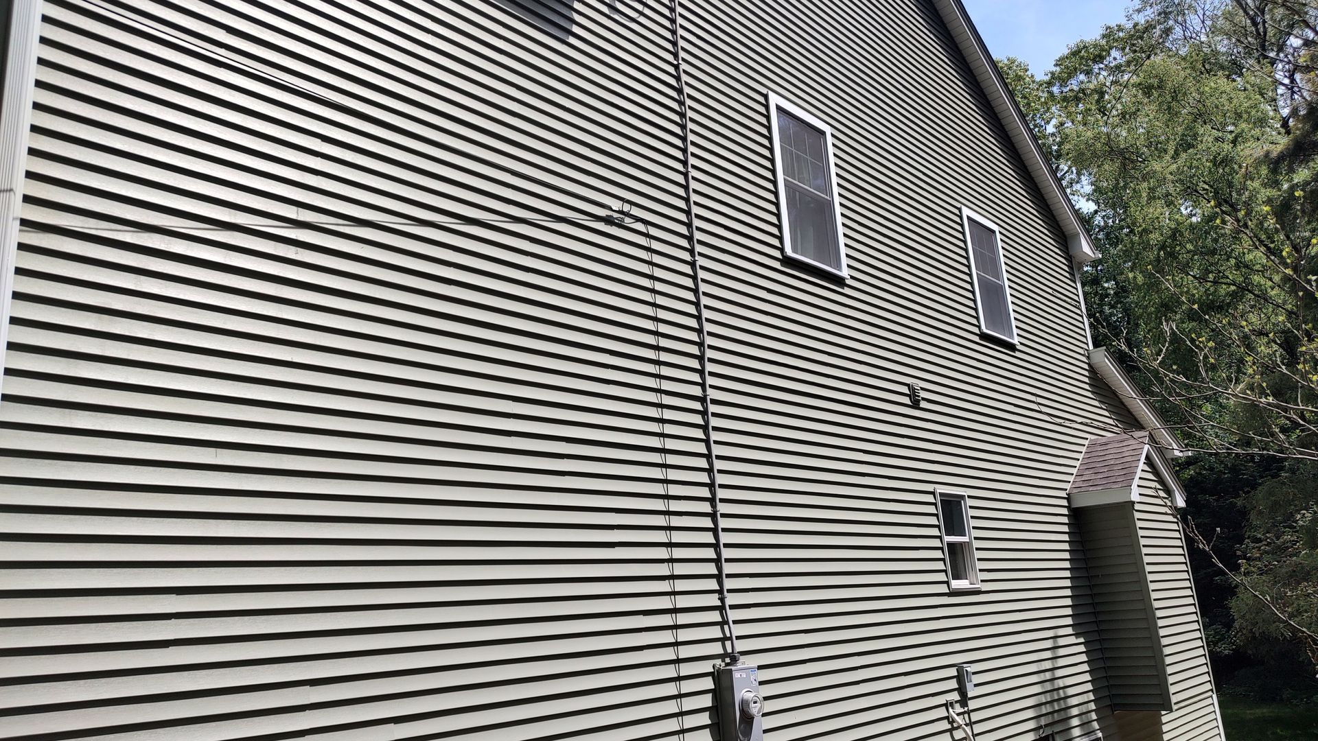 A large house with a lot of windows on the side of it.