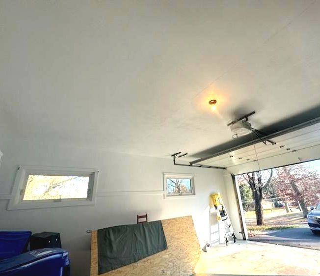 A garage with a garage door open and a window