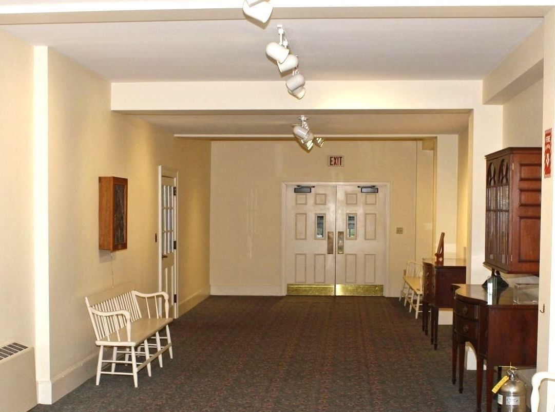 A hallway with a fire extinguisher on the wall