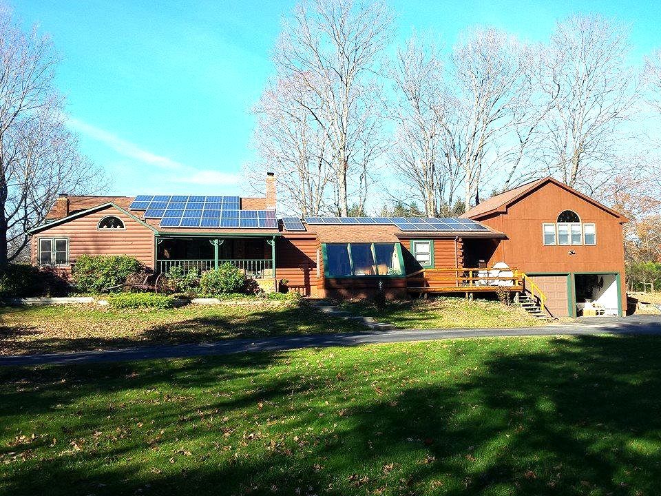 A large house with solar panels on the roof