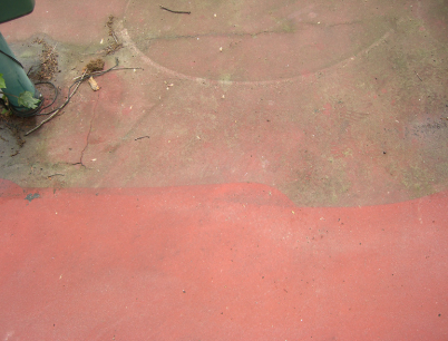 A close up of a red concrete surface with a circle in the middle.