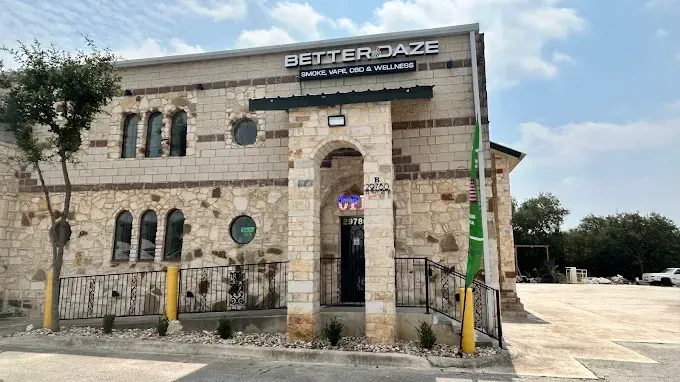 Exterior of Better Daze: shop front with stone facade and arched entrance, sign above says, 