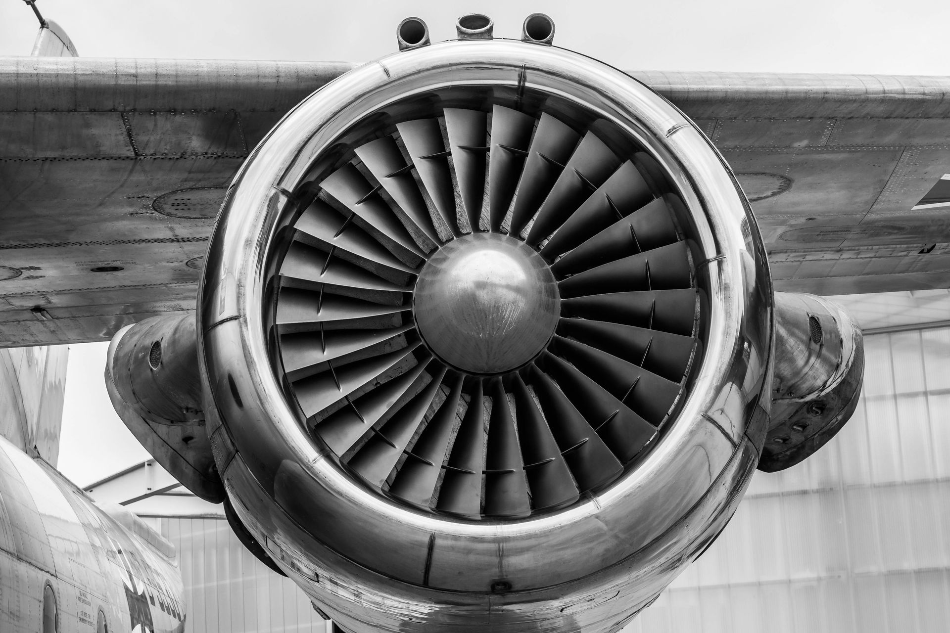 A close up of an airplane engine in a black and white photo