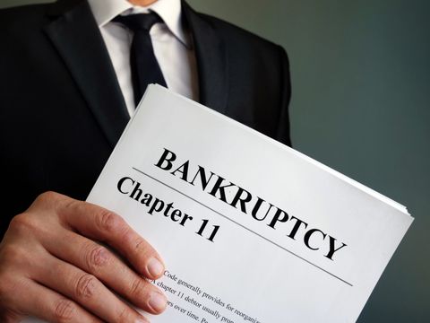 A Man Holding Documents of Bankruptcy Chapter 11 — Carterville, IL — The Law Office of Edward Eytalis