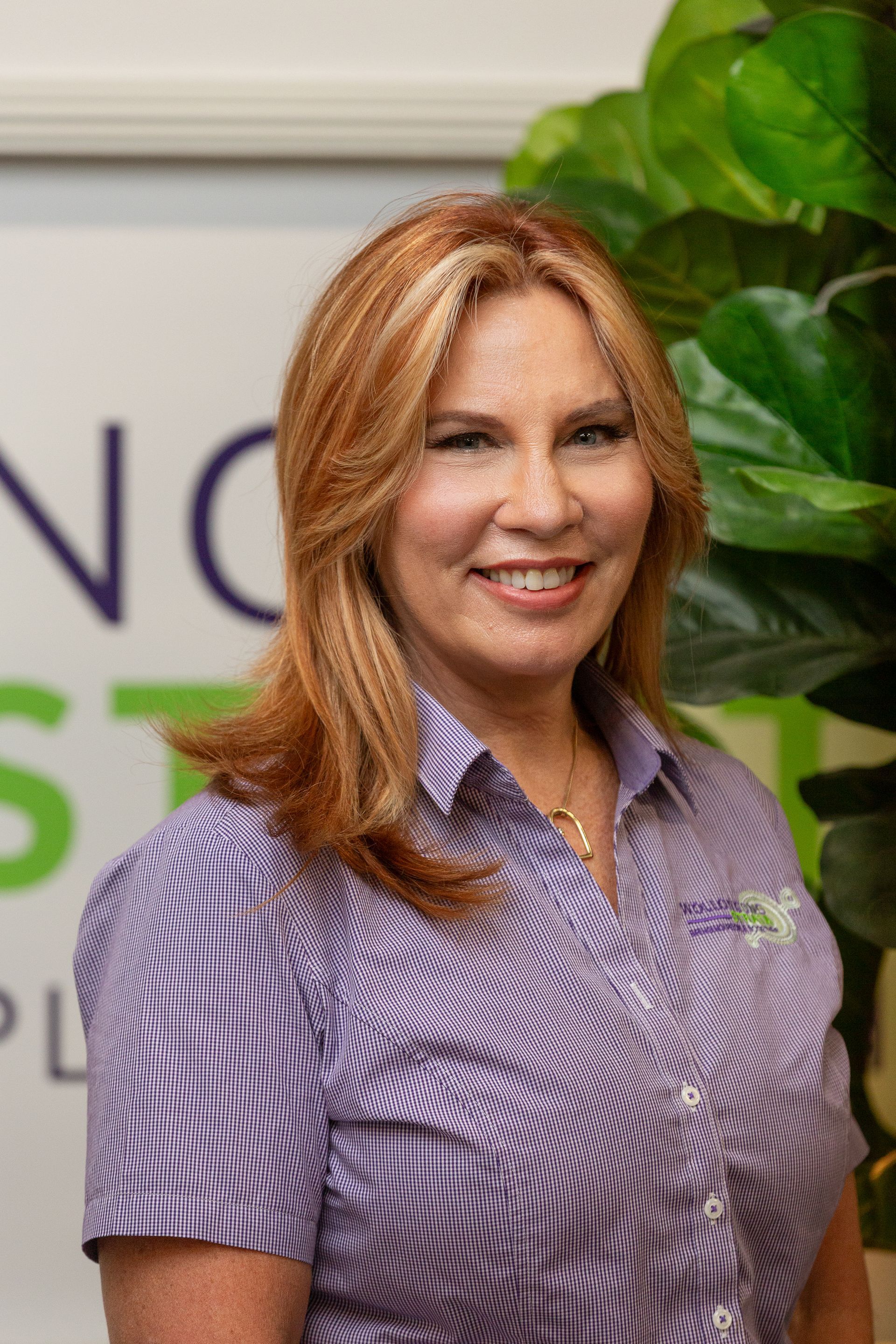 A Woman In A Uniform Is Smiling For The Camera
