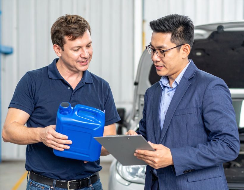 A gray jug of Delo ELC antifreeze coolant, with red cap and blue and white label.