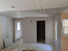 A room that is being remodeled with drywall on the walls
