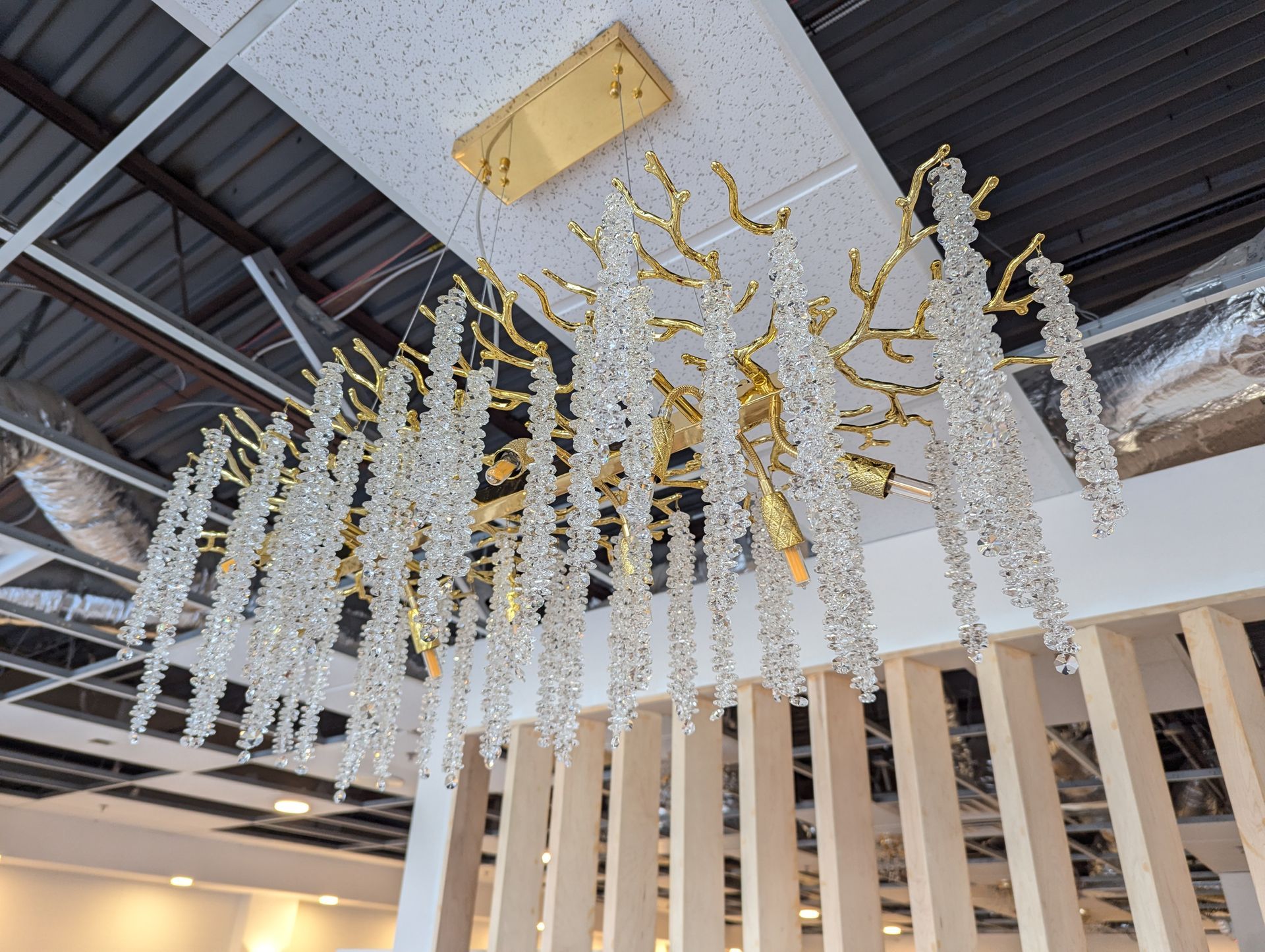 A large chandelier is hanging from the ceiling in a room.
