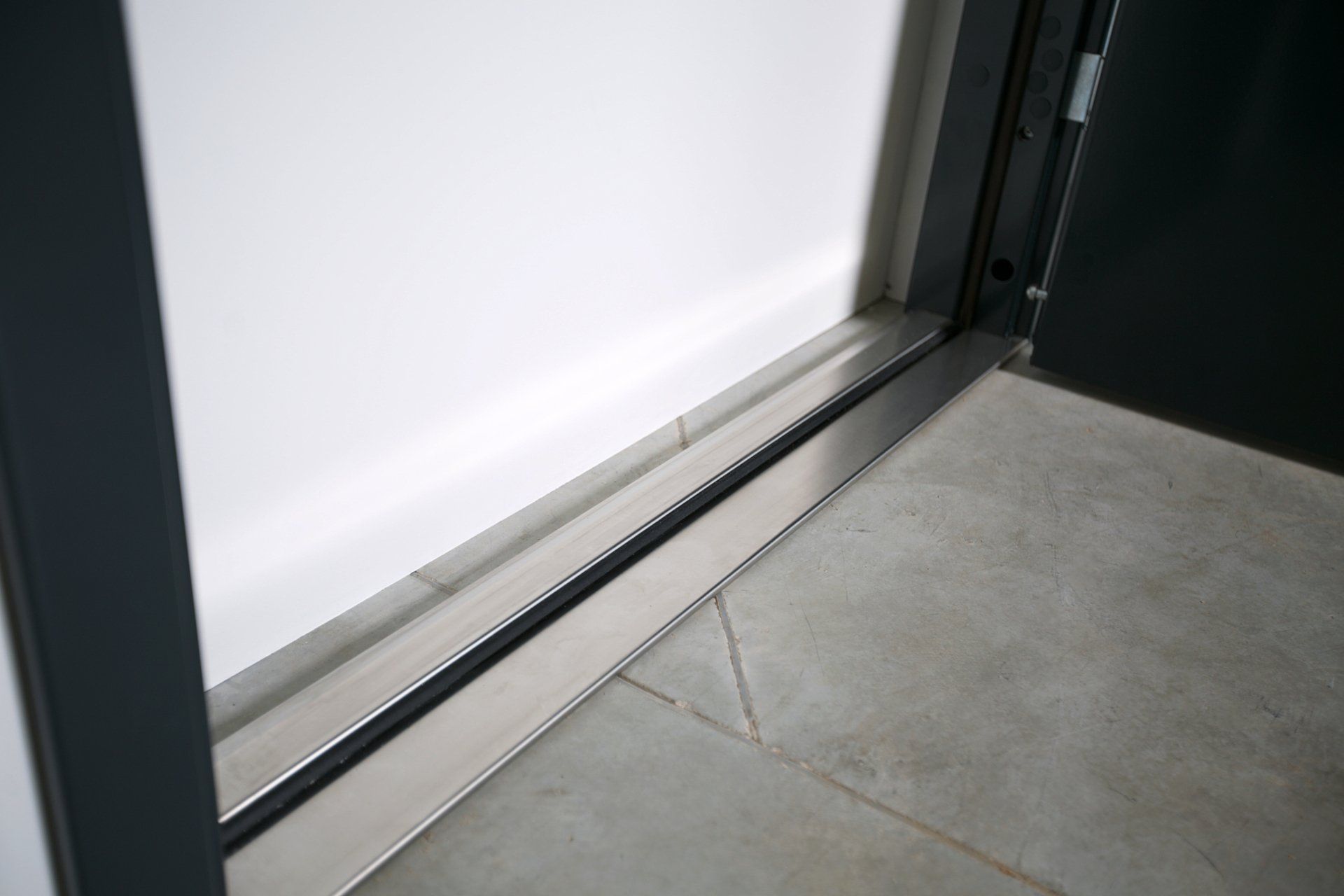 Gallery_Teknisk_information_slät_lägenhetsdörr_mörk_slät_lackerad_karm_produktbild_närbild_tröskel_stål