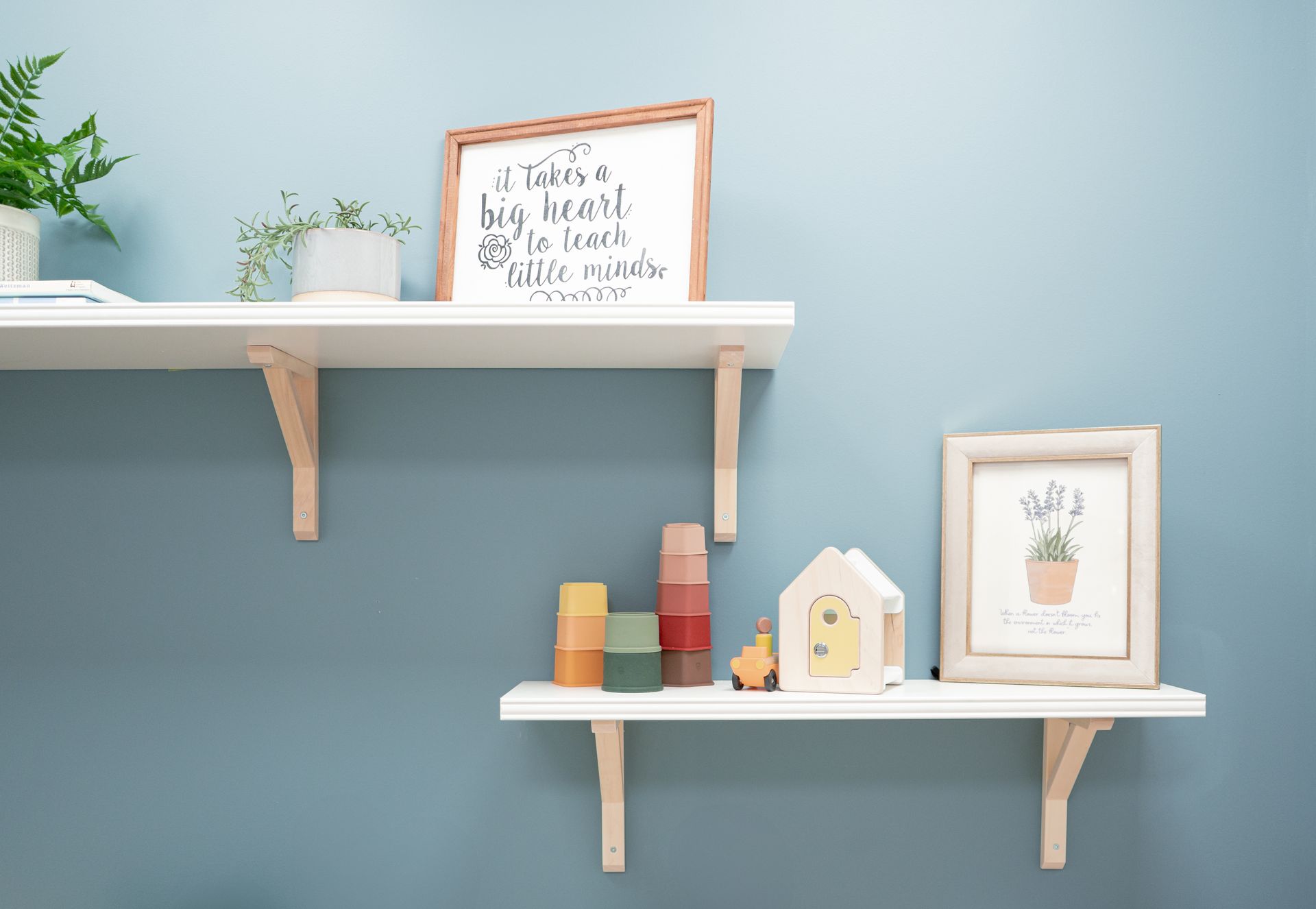 A couple of shelves hanging on a wall with toys on them.