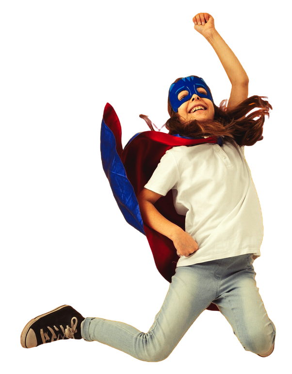 A young girl wearing a cape and mask is jumping in the air.