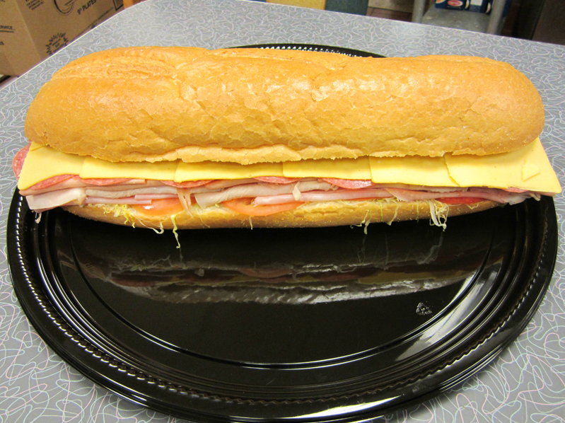 Italian Sandwich Serving — ham and cheese with other toppings sandwich on plate in Orland Park, IL