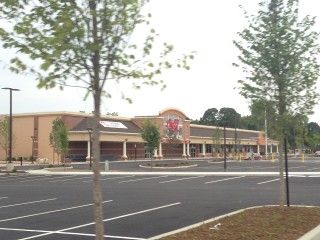 A large building with a parking lot in front of it