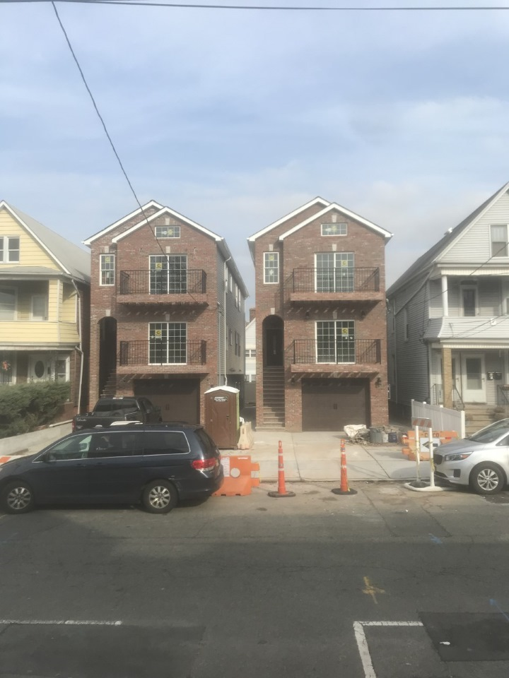 A brick building with cars parked in front of it