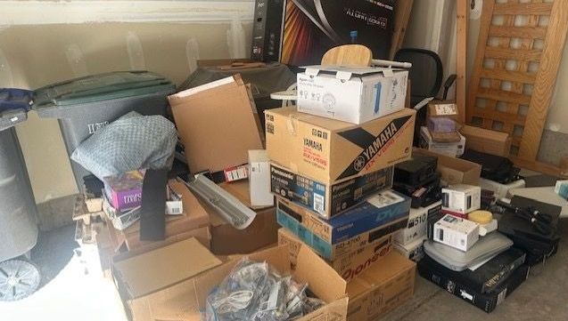 garage packed with clutter - decluttering vs storage unit decision.jpg