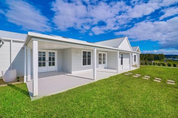 A White House with A Covered Porch and A Large Lawn in Front of It | Mid-North Coast, NSW | BDM Constructions