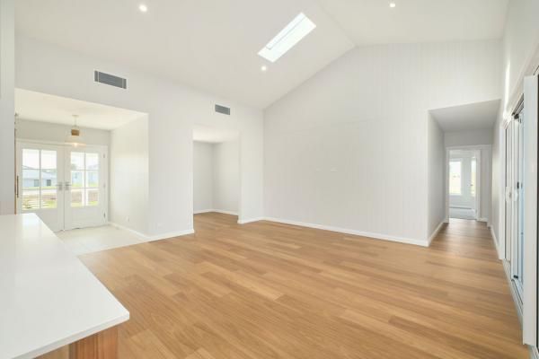 An Empty Living Room with Hardwood Floors and White Walls | Mid-North Coast, NSW | BDM Constructions