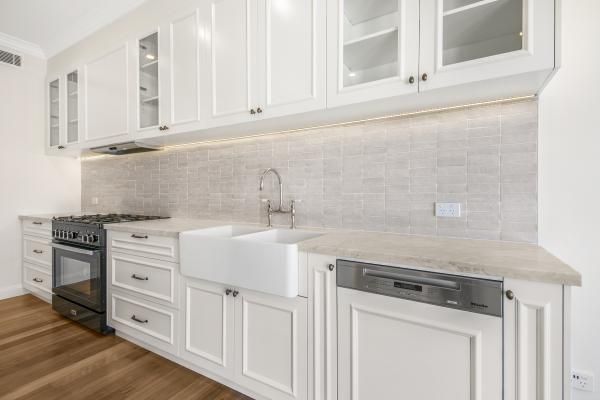 A Kitchen with White Cabinets , a Sink , a Stove , and A Dishwasher | Mid-North Coast, NSW | BDM Constructions