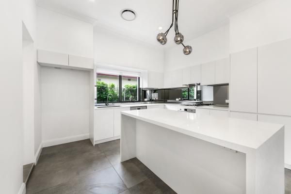 A Kitchen with White Cabinets and A Large Island | Mid-North Coast, NSW | BDM Constructions