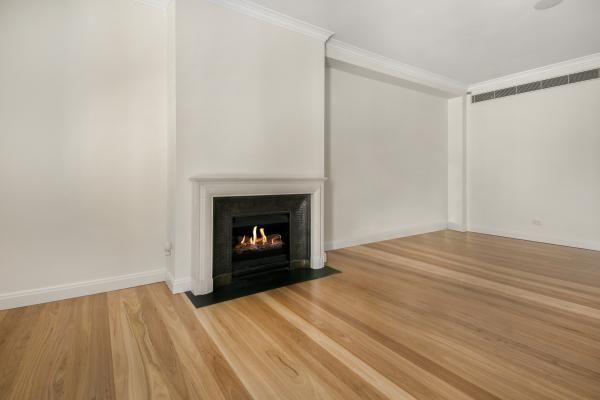 An Empty Room with A Fireplace and Hardwood Floors | Mid-North Coast, NSW | BDM Constructions