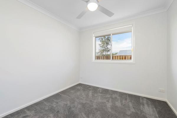 An Empty Bedroom with A Ceiling Fan and A Window | Mid-North Coast, NSW | BDM Constructions