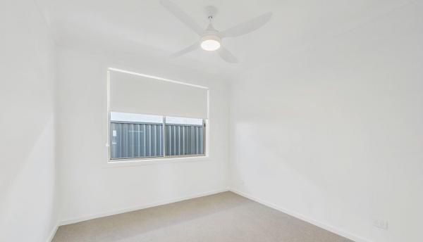 An Empty Room with A Ceiling Fan and A Window | Mid-North Coast, NSW | BDM Constructions