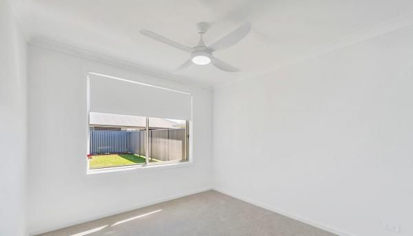 An Empty Room With A Ceiling Fan and A Window | Mid-North Coast, NSW | BDM Constructions