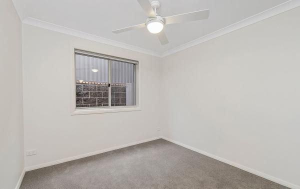 An Empty Bedroom with A Ceiling Fan and A Window | Mid-North Coast, NSW | BDM Constructions