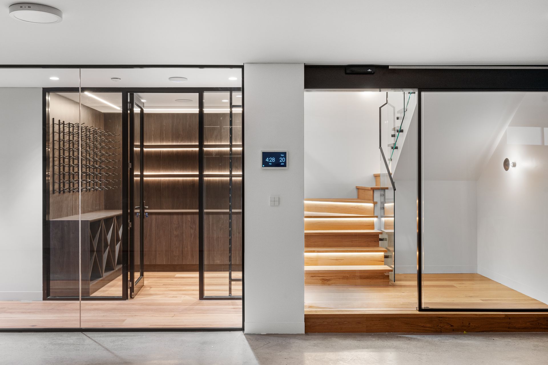 A room with a staircase and a glass door