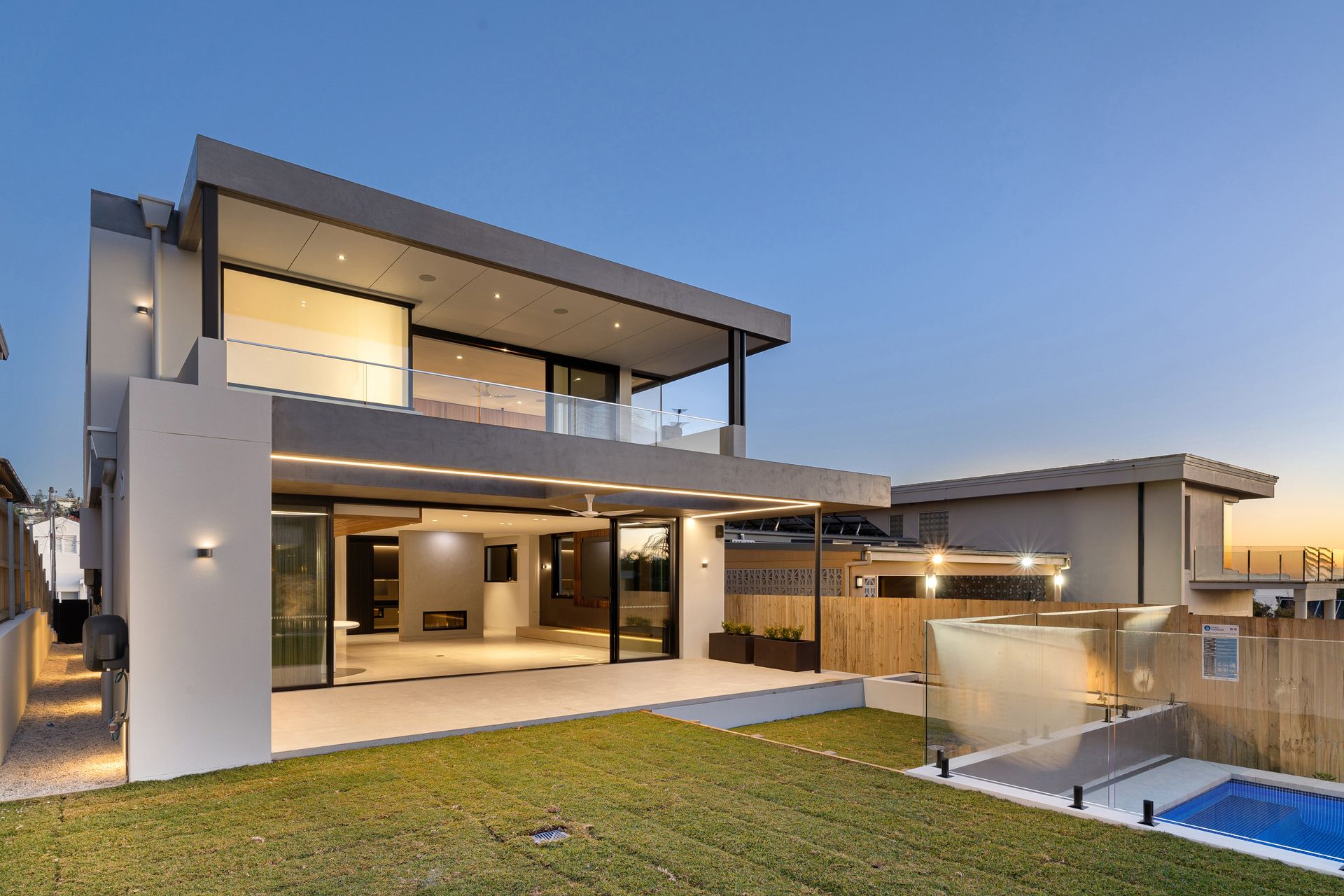 A large modern house with a swimming pool in the backyard.