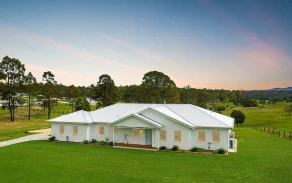 A Large White House Is Sitting on Top of A Lush Green Field | Mid-North Coast, NSW | BDM Constructions