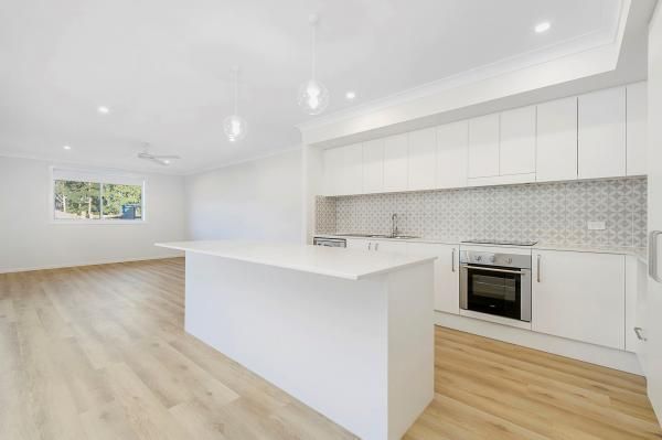 An Empty Kitchen with White Cabinets and Wooden Floors | Mid-North Coast, NSW | BDM Constructions