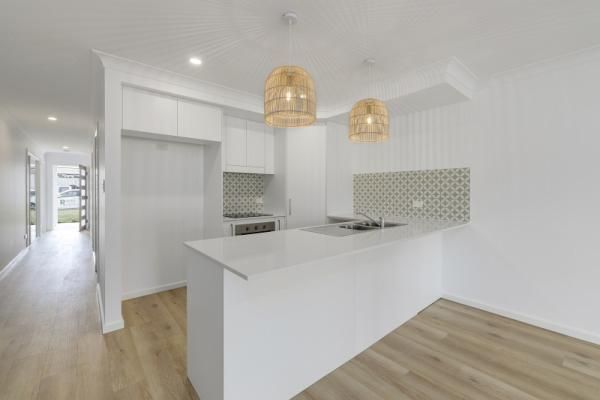 A Kitchen with White Cabinets and A Wooden Floor | Mid-North Coast, NSW | BDM Constructions