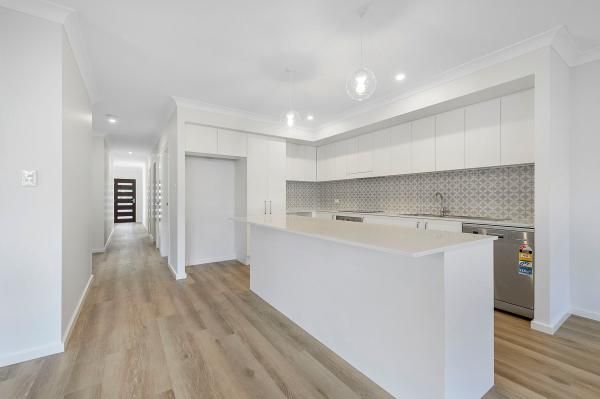 A Kitchen with White Cabinets and A Wooden Floor | Mid-North Coast, NSW | BDM Constructions