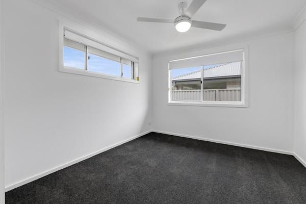 An Empty Bedroom with A Ceiling Fan and A Window | Mid-North Coast, NSW | BDM Constructions