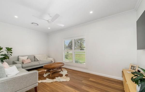 A Living Room with A Couch, Chairs, Coffee Table and A Ceiling Fan | Mid-North Coast, NSW | BDM Constructions