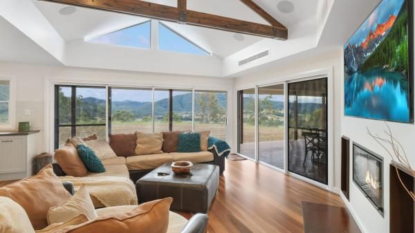 A Living Room with A Couch, Coffee Table, Fireplace and Television | Mid-North Coast, NSW | BDM Constructions