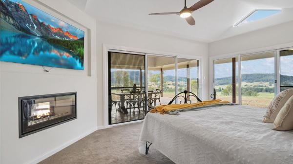 A Bedroom with A King Size Bed and A Fireplace | Mid-North Coast, NSW | BDM Constructions