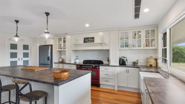 A Kitchen with White Cabinets and A Red Stove Top Oven | Mid-North Coast, NSW | BDM Constructions